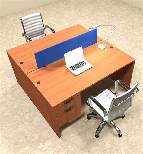 an office desk with a laptop computer on top of it and a chair next to it