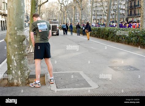 Participant in the marathon pissing in the middle of the race. The Stock Photo, Royalty Free ...