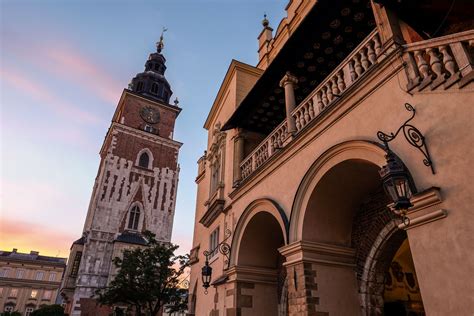 an old building with a clock tower in the background at sunset or ...