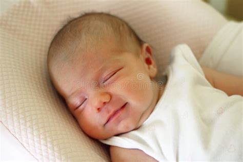 Cute Newborn Baby is Sleeping with Smile on Her Face Stock Photo ...