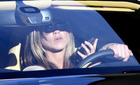 Squeaky clean Jennifer Aniston breaks the law by driving and chatting ...