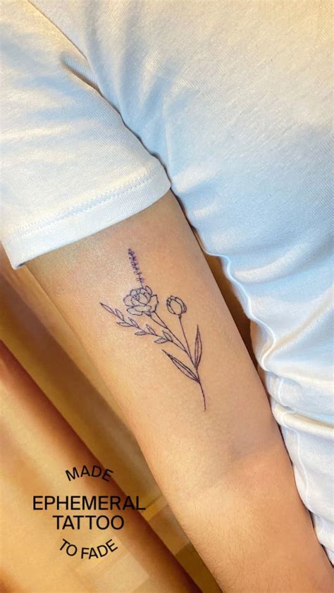 a woman's arm with a flower tattoo on the left side of her arm