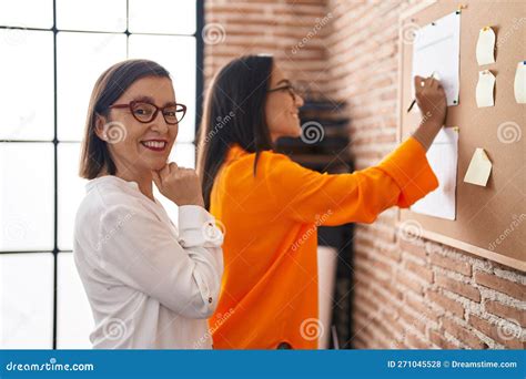 Two Women Business Workers Writing on Cork Board at Office Stock Photo - Image of person ...