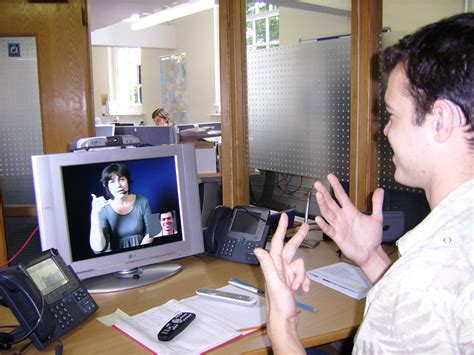 File:Deaf or HoH person at his workplace using a Video Relay Service to communicate with a ...