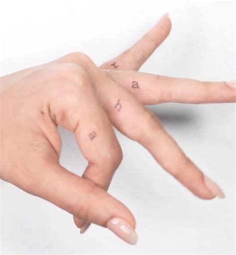 Initials tattoos located on Alia Bhatt's fingers.