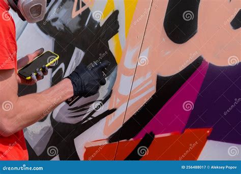 Man Spraying Paint from Can on Wooden Surface at Graffiti Festival Editorial Photography - Image ...