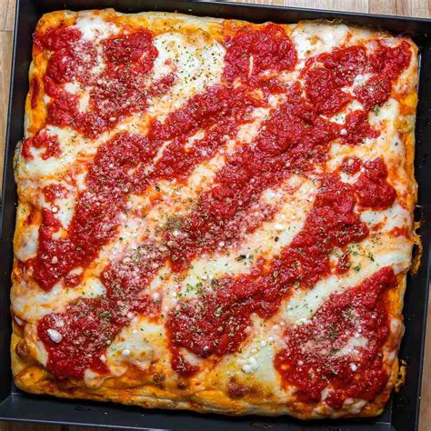 This classic square shaped New York Sicilian pizza combines thick airy dough that is topped with ...