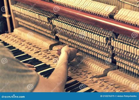 Piano Tuning Process. Closeup of Hand and Tools of Tuner Working on ...