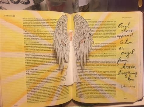 an open book with angel wings on it