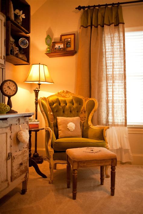 a living room with a chair, ottoman and clock on the wall next to a window