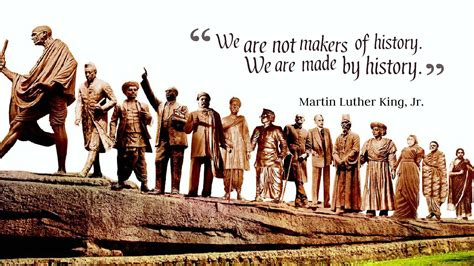 a group of people standing in front of a statue with a quote above it ...