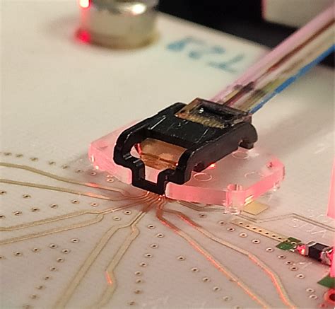 Active alignment of fibre arrays to photonics chips - Sylex