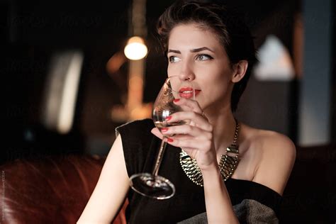 "Beautiful Brunette Woman Drinking Wine At The Dinner Party" by Stocksy Contributor "Brkati ...