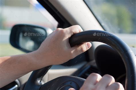 Male hands on the steering wheel of a car close-up. Stock Photo by ...