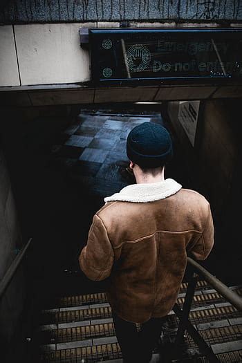 person, touching, jacket, wall, architecture, building, concrete, structure, number, basement ...