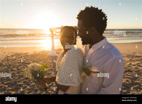 African american couple in love getting married, smiling on beach during sunset Stock Photo - Alamy