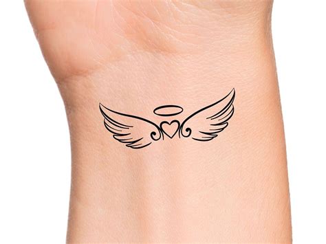 a small tattoo on the back of a woman's arm with an angel wing