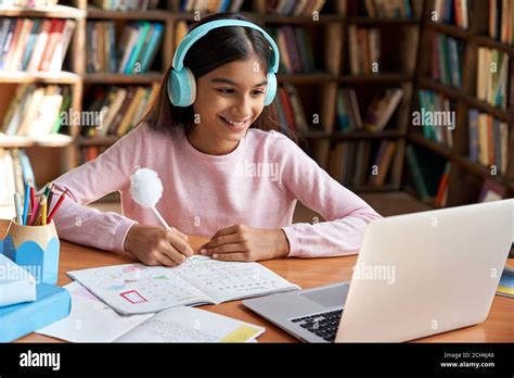 Happy indian school girl learning online class on video zoom call on ...