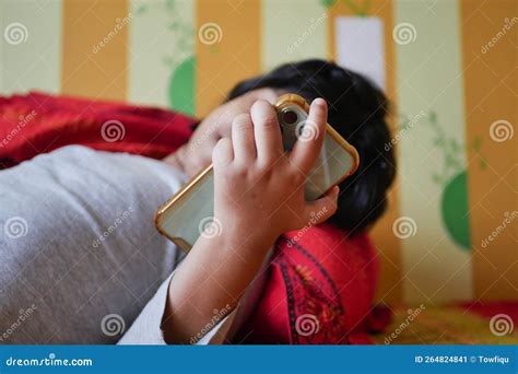 Child Using Smart Phone on Bed Stock Image - Image of browsing, table: 264824841