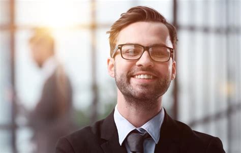 Premium Photo | Smiling man in black suit against the backdrop of the office