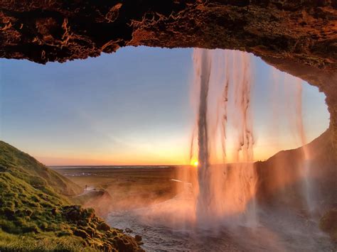 Midnight sunset from behind a waterfall in Iceland : r/pics