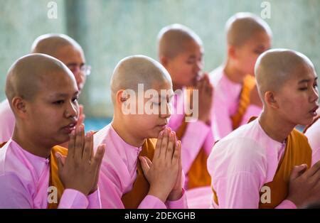 A burmese buddhist novice is praying inside in one of the many pagodas in Bagan,Myanmar Stock ...