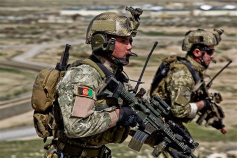 Afghan National Army Commandos running to a compound during a live ...