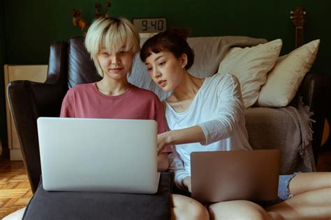 Women with Laptops Sitting on the Floor · Free Stock Photo