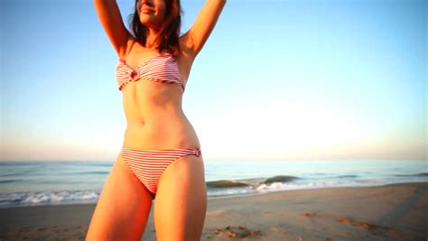 Beautiful Girl Dances On The Beach In A Bikini At Sunrise, Barcelona ...