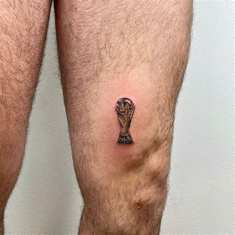 FIFA World Cup trophy tattoo located on the thigh,