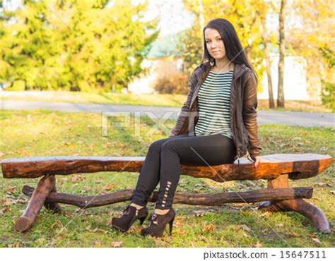 beautiful and sexy girl sitting on bench outdoors - Stock Photo [15647511] - PIXTA