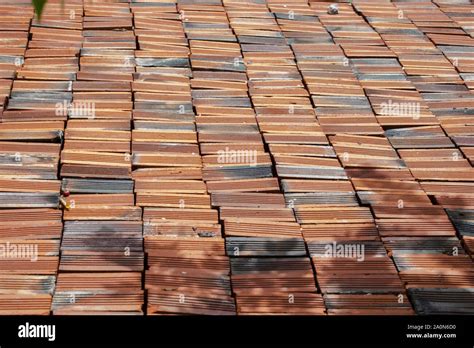 Brown burnt clay bricks on a pile. Pattern and texture Stock Photo - Alamy