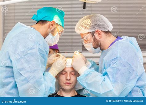 Baldness Treatment. Hair Transplant. Surgeons in the Operating Room ...