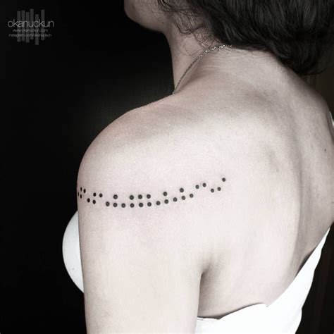 Braille tattoo on the shoulder.