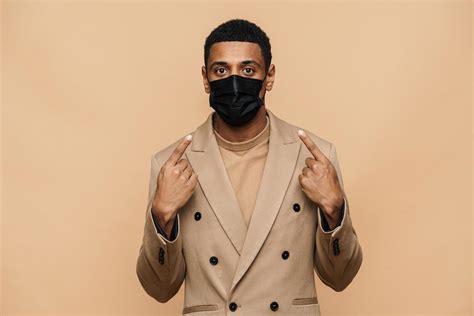 Serious African businessman showing his protective face mask 5180051 Stock Photo at Vecteezy