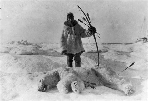 An Inuit hunter standing over a slain polar bear. 26 November 1924 ...