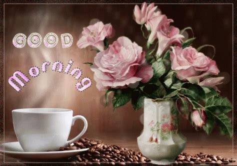 pink roses in a vase next to a coffee cup and saucer with the words good morning written on it