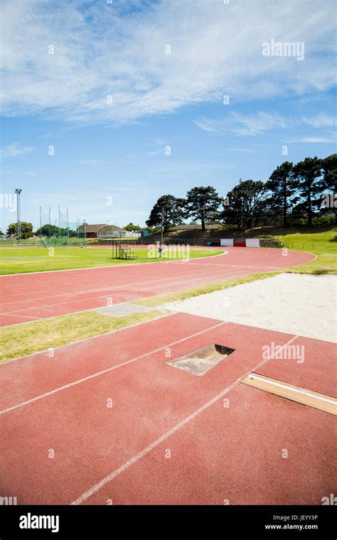 Long jump sand pit on running track Stock Photo - Alamy