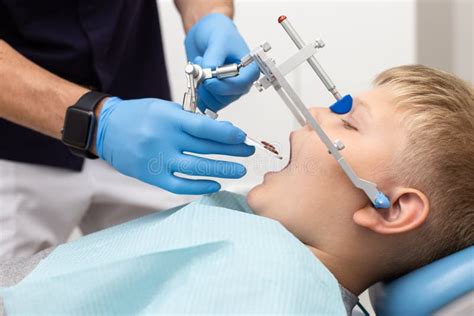 Little Boy Keep His Mouth Wide Open while His Dentist Setting Up Orthodontic Arch Stock Photo ...