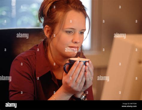Coffee drinking at work behind computer screen Stock Photo - Alamy
