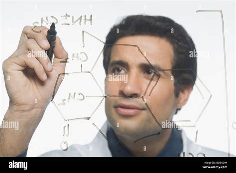 Scientist writing chemical formula Stock Photo - Alamy