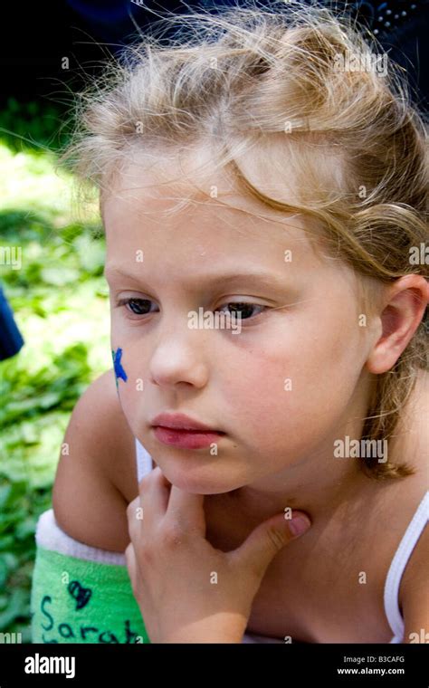 Sad girl age 7 with cast on broken arm. Svenskarnas Dag Swedish Heritage Day Minnehaha Park ...