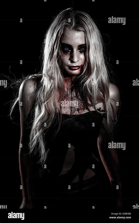 Pale bloody woman over black background Stock Photo - Alamy