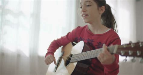 young girl playing guitar and singing Stock Video Footage 00:33 SBV-322213074 - Storyblocks