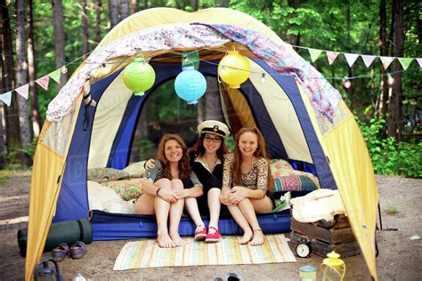 Girls relaxing in camping tent - Stock Photo - Dissolve