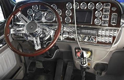 the interior of an old car with wood trim and gauges, steering wheel and dash board