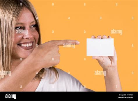 Smiling disable young woman pointing blank visiting card Stock Photo - Alamy