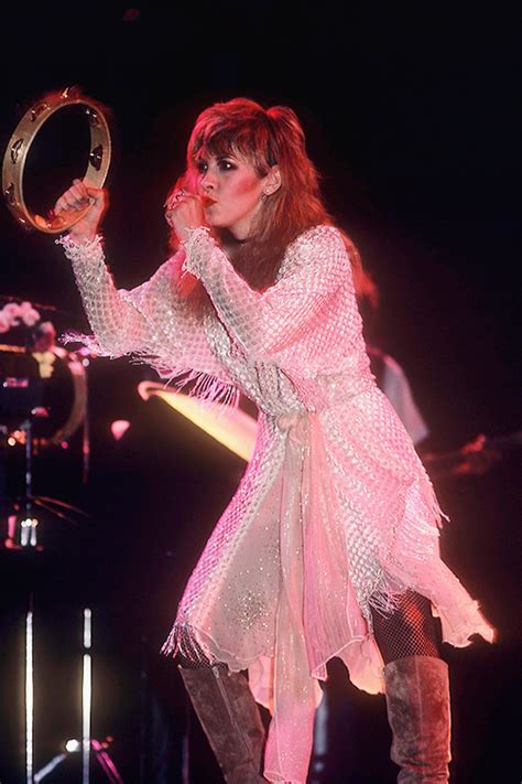 Stevie, doing her iconic "crouch"onstage and wearing a most unusual ...