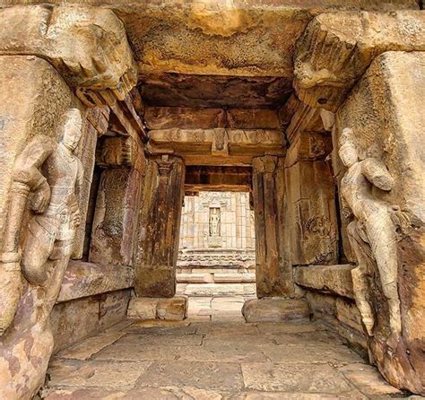 the entrance to an ancient building with statues on it's sides and ...