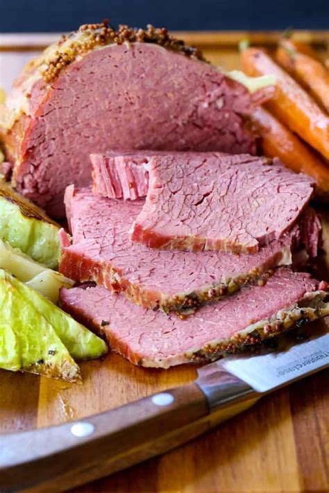 meat and potatoes on a plate with bread in the background